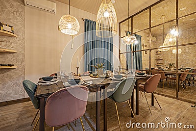 Served wooden plank dining table for six with a mirrored wall in a vacation Stock Photo