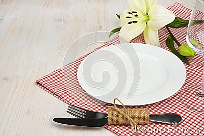 Served wooden restaurant table with settings on red checkered tablecloth Stock Photo