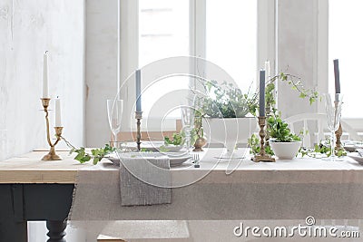 Served wooden table decorated with flowers and ivy Stock Photo