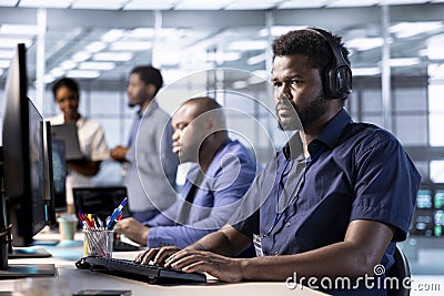 Server hub employee listening music, debugging and optimizing code Stock Photo