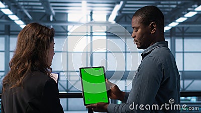 Server room data scientists using mockup tablet, conducting security audits Stock Photo
