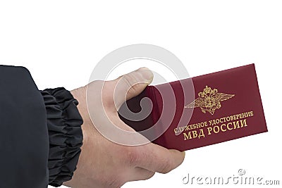 Service certificate in the hands of a policeman. Text translation: Ministry of Internal Affairs of Russia Editorial Stock Photo