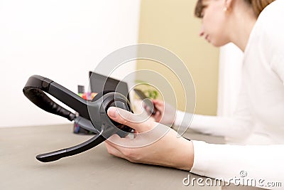 Service desk consultant holding headset. Helpdesk, IT support co Stock Photo