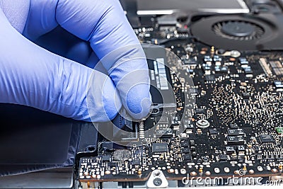 Service engineer install plug in new battery to the laptop. Repairing laptop concept. Close up view Stock Photo