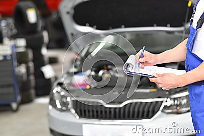 Service and inspection of a car in a workshop - mechanic inspect Stock Photo