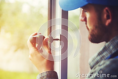 Service man installing window Stock Photo