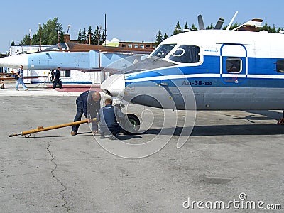 Service of the Russian Antonov an-38 at the airfield technician working people Editorial Stock Photo