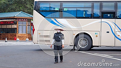 Service staff in the park of an extinct volcano Rock Hill Volcanoe Haikou. Chinese woman in uniform rangers Editorial Stock Photo