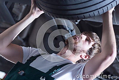 Service station worker checking tire Stock Photo