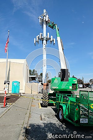 A service technician servicing a cell phone tower Editorial Stock Photo