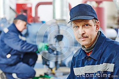 Service worker at industrial compressor station Stock Photo