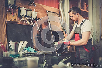 Serviceman in a car body workshop Stock Photo