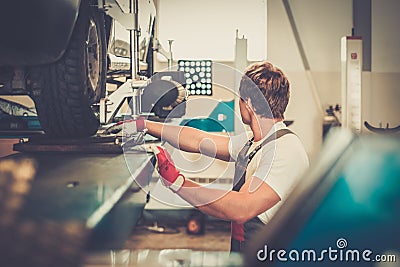 Serviceman in a car workshop Stock Photo