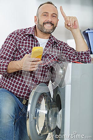 Serviceman with multimeter realising what problem Stock Photo