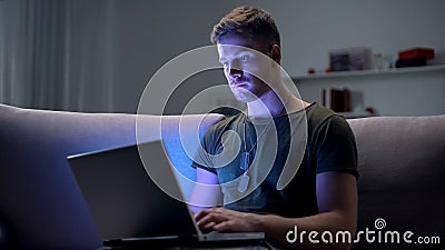 Serviceman searching job on laptop at home, adapting to civilian life after army Stock Photo