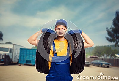 Serviceman in uniform holds tires in hands Stock Photo