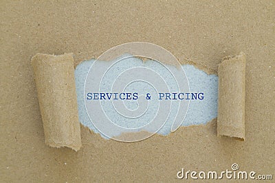 Services and pricing written under torn paper. Stock Photo