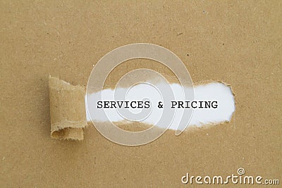 Services and pricing written under torn paper. Stock Photo