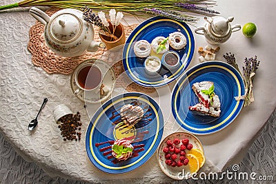 Serving of desserts: fruit pie fresh raspberries. Fried donuts with icing sugar and jam. Pastries with cherry jam. Concept - Stock Photo