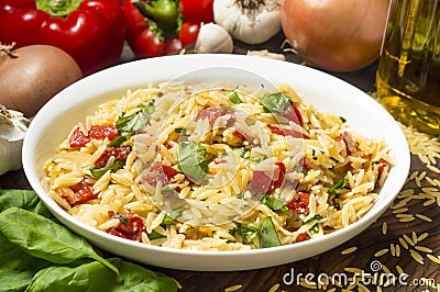 Serving dish with orzo and roasted red peppers Stock Photo