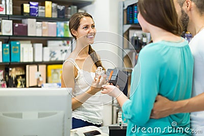 Serving purchaser at cash desk Stock Photo