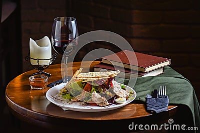 Serving at the restaurant a salad of fresh vegetables with meat and croutons. Dish with ingredients of meat and vegetables on the Stock Photo