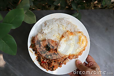 Sunny side up egg and stir fried park with chilli paste and rice Stock Photo