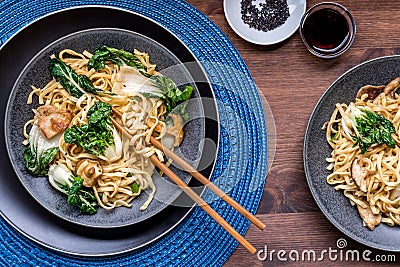 Servings of spicy pork and vegetable longevity noodles, ready for eating. Stock Photo