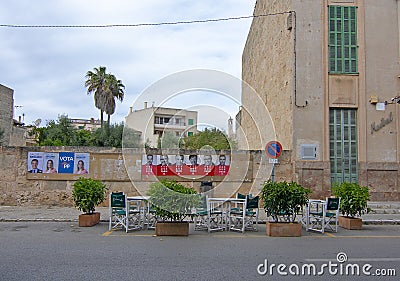 Political posters and cafe chairs street view Editorial Stock Photo