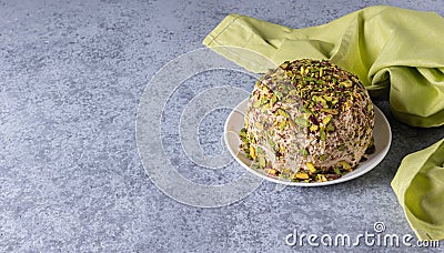 Sesame halva with nuts and green napkin on gray background Stock Photo