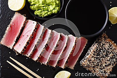 Sesame Seed Crusted Seared Tuna served with wasabi and sauce closeup. Top view horizontal Stock Photo