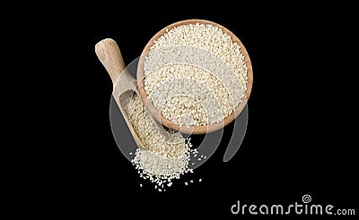 Sesame seeds in wooden bowl and scoop isolated on black background. top view. Spices and food ingredients Stock Photo