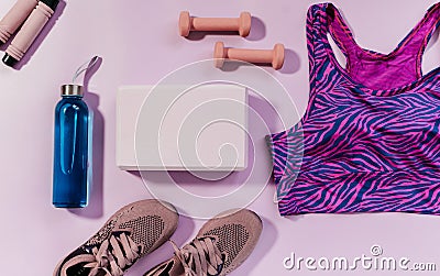 Set of accessories for fitness, yoga. Bra, pink block for yoga, bottle for water, dumbbells, sneakers, skipping rope Stock Photo