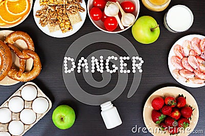 Set of allergy food with antihistamine pills on wooden table Stock Photo