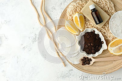 Set for anti-cellulite procedures massage. Coffee scrub, coffee grains, sea salt, lemon, essential oil, soap and sponge on wooden Stock Photo