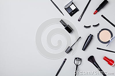 Set of beauty products and makeup tools decorated star confetti on gray table top view. Flat lay composition Stock Photo