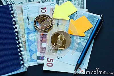 Set of bitcoin, ethereum - crypto currency next to notepad on real money background. Time is money. Internet e-commerce, security Editorial Stock Photo