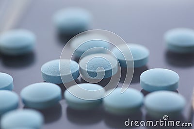 A set of blue pills on the table, close-up, shadow Stock Photo