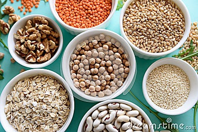 Set of bowls with organic quinoa, lentil, chickpea, wheat, walnut, almond, hazelnut and sesame. Cereals and legumes assortment on Stock Photo