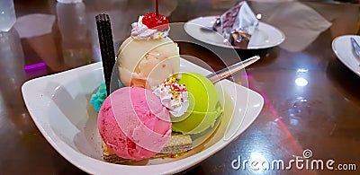 Set of bowls with various colorful Ice Cream scoops with different flavors and fresh ingredients, chocolate, vanilla, and Stock Photo