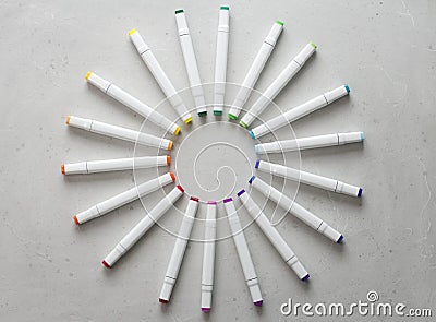 A set of bright multi-colored felt-tip pens or markers lie in a circle, rays, creating a round frame in the center. Creativity, Stock Photo