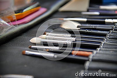 A set of brushes for make-up. Closeup of makeup tools. Brushes in a leather case on the table Stock Photo