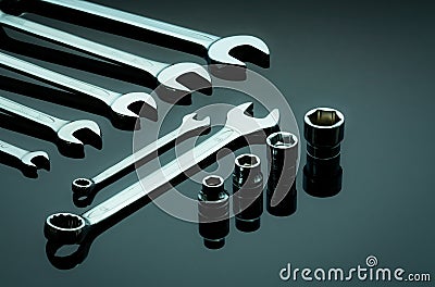 Set of chrome wrenches or spanners and hexagon socket on dark table in workshop. Chrome vanadium spanner wrench. Shiny silver Stock Photo