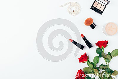 Set classic makeup with red lipstick, beige powder, string of pearls and bouquet of rose flowers Stock Photo