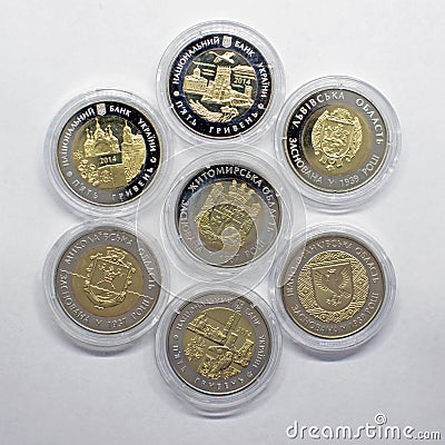 A set of collection coins of Ukrainian hryvnia of different denominations made in gold color. Editorial Stock Photo