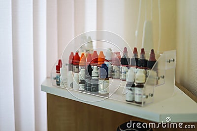 Set of color correction ink bottle for cosmetic tattoo. Many Microblading Permanent Makeup Pigments in Bottled Store Stock Photo