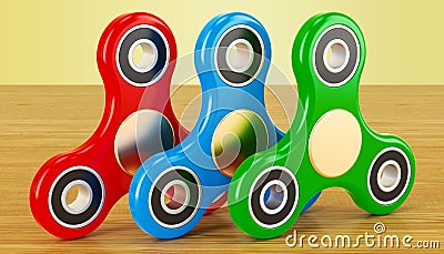 Set of colored fidget spinners on the wooden table. 3D rendering Stock Photo