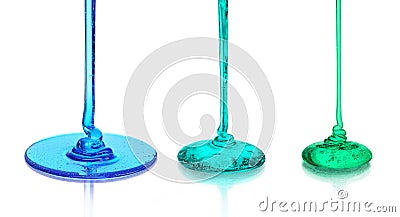 A set of colored liquids that pours on the glass surface Stock Photo