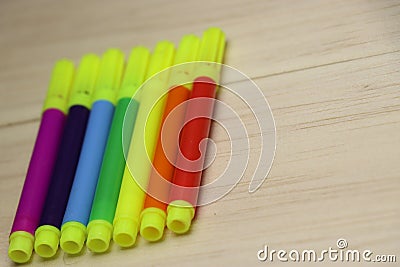 Set of colored pens on wooden background Stock Photo