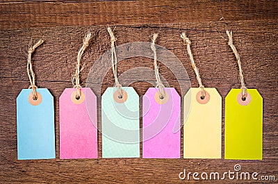 Set of colorful blank hang tag on wooden background. Stock Photo